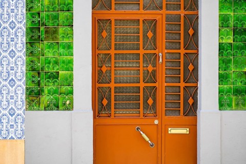 Metal doors to typical fisherman's house coverd with tiles called azulejo
