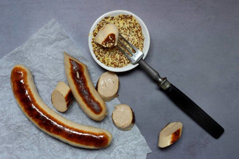 Sliced bratwurst and skin with Dijon mustard