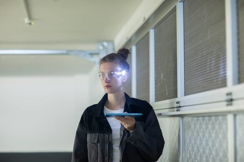 Young logistician working with scan glasses