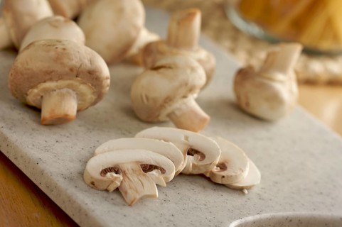 Delicious fresh sliced mushrooms on a cutting board