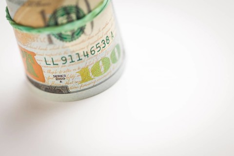 Abstract roll of newly designed U.S. one hundred dollar bills