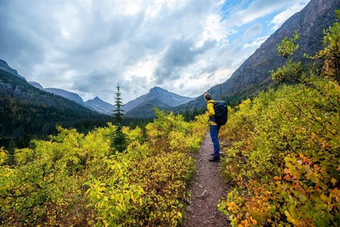 Hikers on a trail through mountain landscape