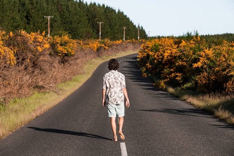 Guy walking on a road