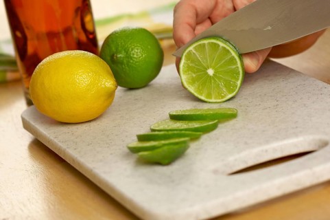 Slicing a lime on a cutting board