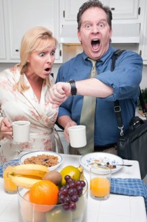 Late for work stressed couple checking time in kitchen