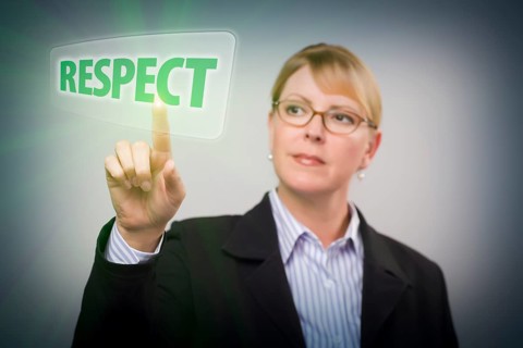 Attractive blonde woman pushing respect button on an interactive touch screen