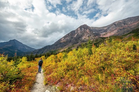 Hikers on a trail through mountain landscape