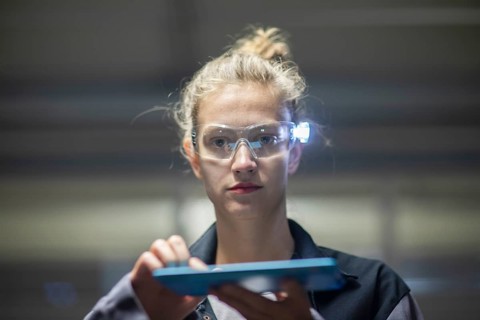 Young logistician working with scan glasses