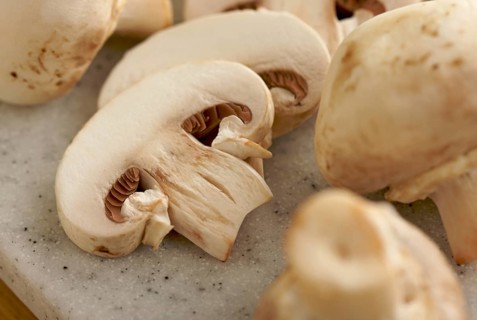 Delicious fresh sliced mushrooms on a cutting board