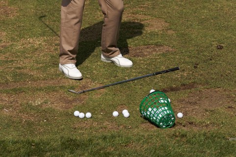 Golfer practicing his swing at the range