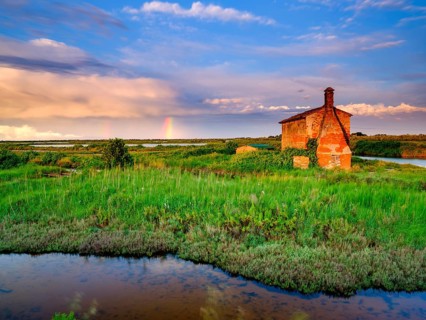Abandoned stone house in the evening light in the lagoon of Venice