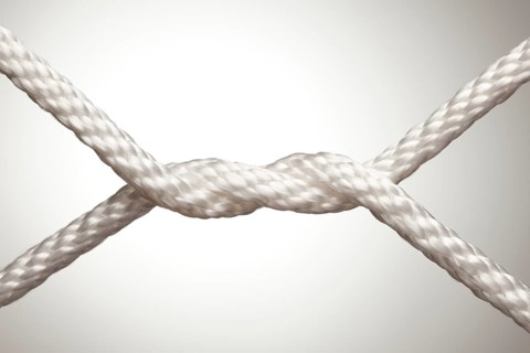 Nylon rope knot on a spot lit background
