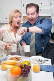 Late for work stressed couple checking time in kitchen