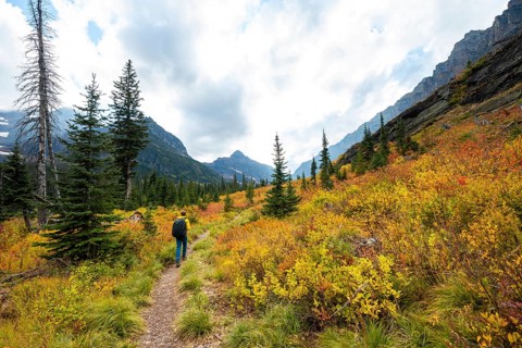 Hikers on a trail through mountain landscape