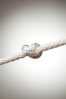 Nylon rope knot on a spot lit background