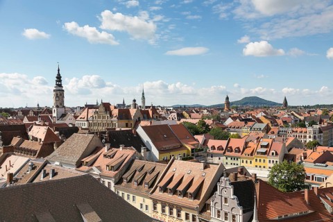 View from the church St. Peter and Paul to the old town with town hall tower and local mountain Landeskrone