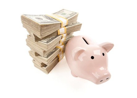 Pink piggy bank with stacks of hundreds of dollars isolated on a white background