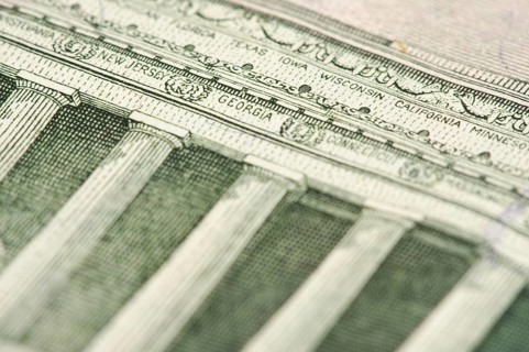 Macro of the back of the U.S. five dollar bill showing small state names as anti-counterfeit measure