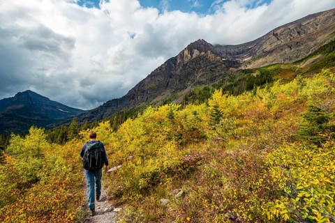 Hikers on a trail through mountain landscape