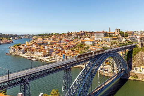 Beautiful panorama of city of Porto with metro on famous bridge