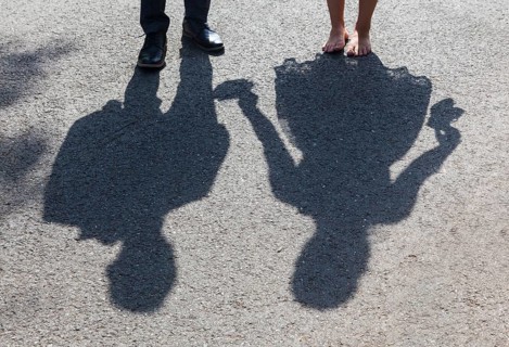 Shadow image of bride and groom on asphalt path