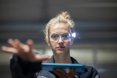 Young logistician working with scan glasses