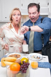 Late for work stressed couple checking time in kitchen