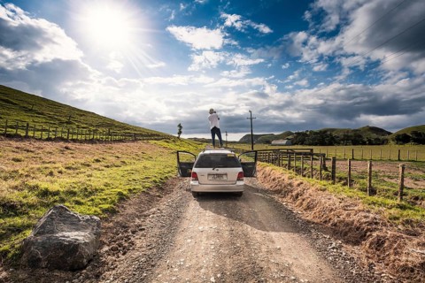 Guy on car roof with camera