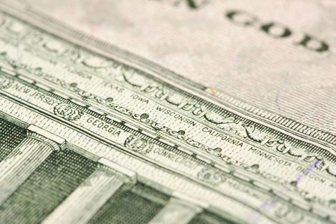 Macro of the back of the U.S. five dollar bill showing small state names as anti-counterfeit measure