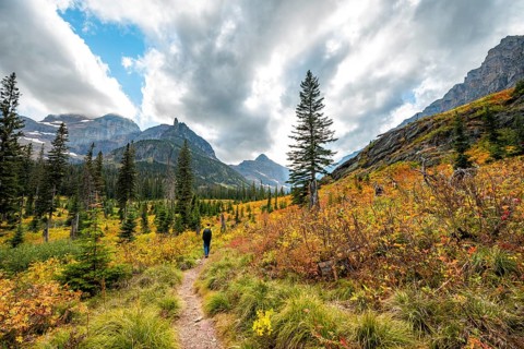 Hikers on a trail through mountain landscape