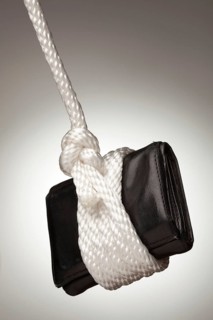 Tied up and hanging wallet on a spot lit background