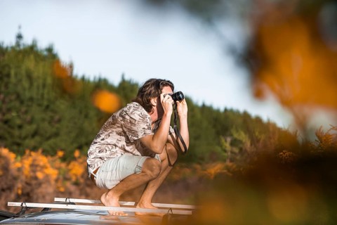 Guy with camera on car roof