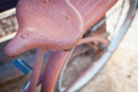 Abstract of old rusty antique bicycle seat in a rustic outdoor setting