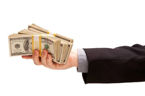 Man handing over hundreds of dollars isolated on a white background