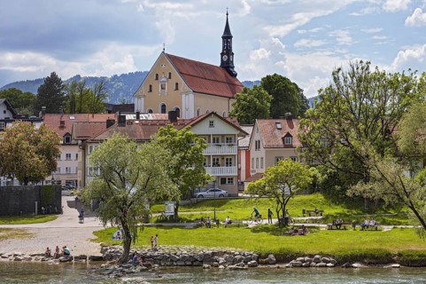 Isar bank with people and Franciscan church