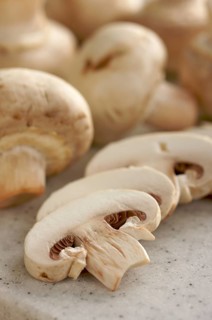 Delicious fresh sliced mushrooms on a cutting board