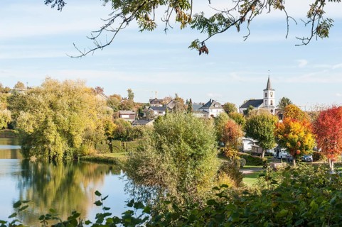 Lake Schalkenmehrener Maar in autumn with foliage colouring