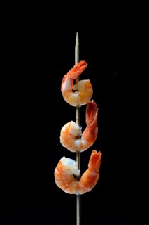 Cooked prawns on wooden skewer