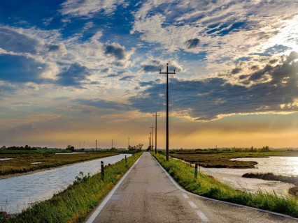 Single lane road through the Venice lagoon in the evening light