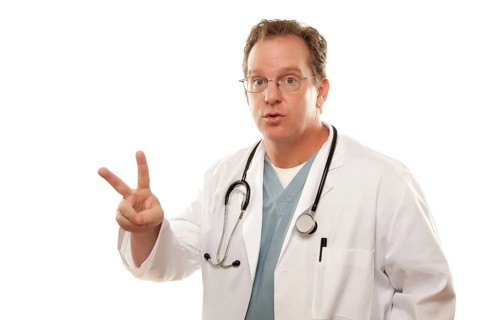 Male doctor with two fingers up isolated on a white background