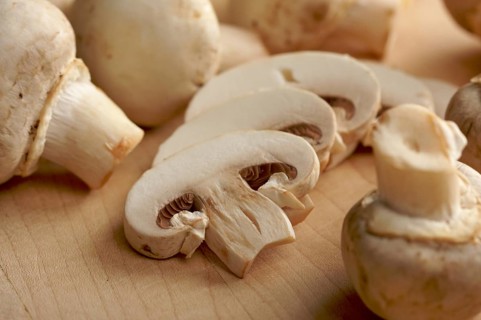 Delicious fresh sliced mushrooms on a cutting board