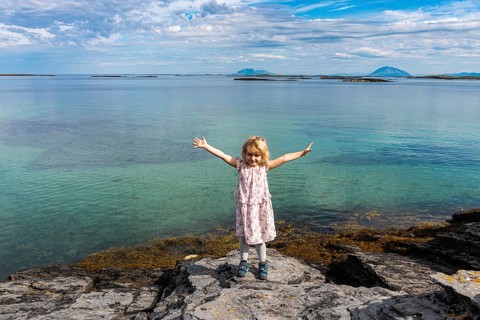 Little girl on a rock