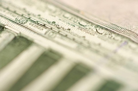 Macro of the back of the U.S. five dollar bill showing small state names as anti-counterfeit measure