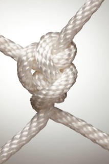 Nylon rope knot on a spot lit background