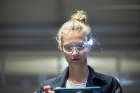Young logistician working with scan glasses