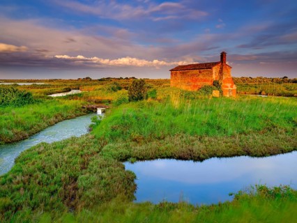 Abandoned stone house in the evening light in the lagoon of Venice