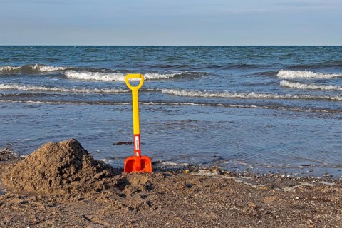 Children's shovel on the beach