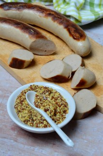 Bowl of Dijon mustard and sausages