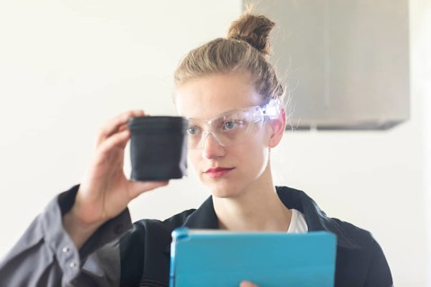 Young logistician working with scan glasses
