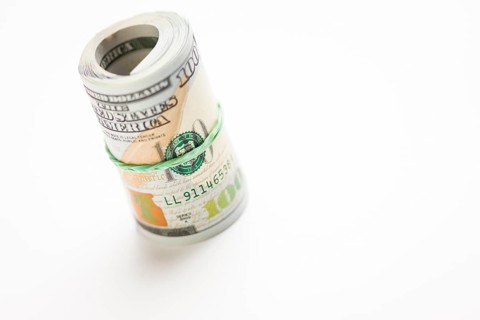 Abstract roll of newly designed U.S. one hundred dollar bills